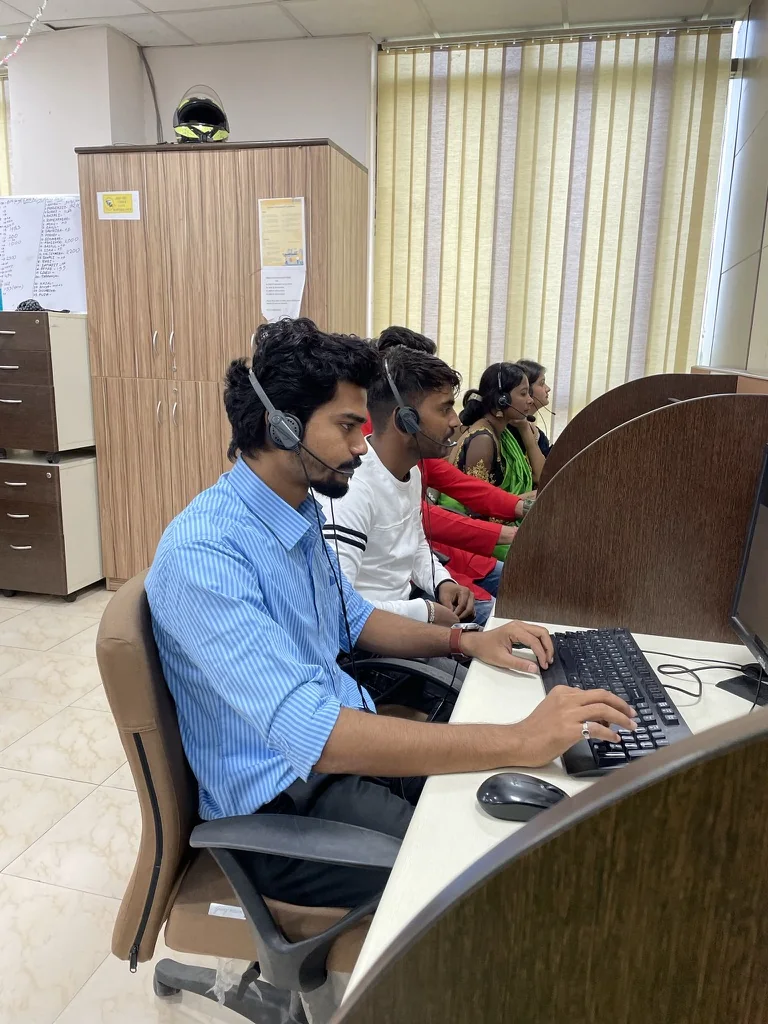 CIPL team members using headsets at customer operations workstations