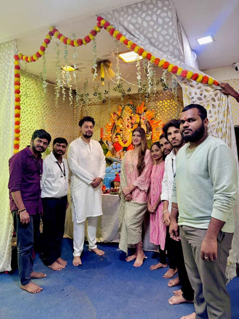 CIPL colleagues gathered in front of a decorated Ganesh display during Ganesh Puja